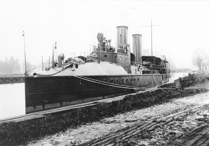 The civilian yacht Tarantula is seen tied up in front of the Rightmire family residence in Griggstown, Somerset County, in May of 1907.  The Tarantula was owned by William K. Vanderbilt II, and was among the first turbine-powered private yachts.  Constructed in Scotland, her hull was modeled on torpedo boats built for the Royal Navy.  Mr. Vanderbilt used the yacht to for commuting in and around New York City.   As the use of the Delaware and Raritan Canal for freight transportation declined, the canal’s use by pleasure craft increased.  The canal provided an inland route which linked two major centers of pleasure boating, the Long Island Sound and Chesapeake Bay.  Using the canal shortened the journey between those water bodies by nearly 200 miles when compared with the ocean route around the Cape May peninsula.  (Photograph by George F. Rightmire)